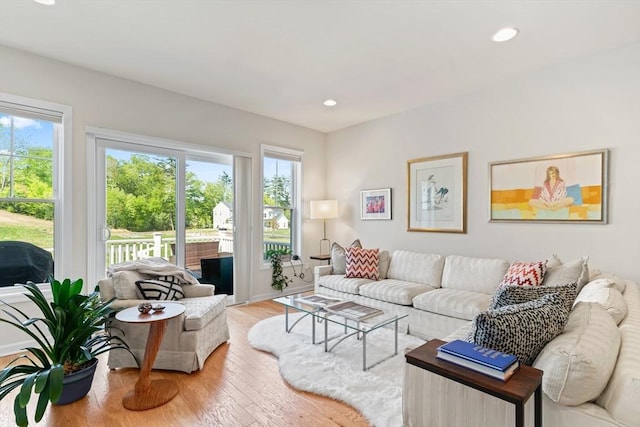 living area featuring plenty of natural light, wood finished floors, and recessed lighting