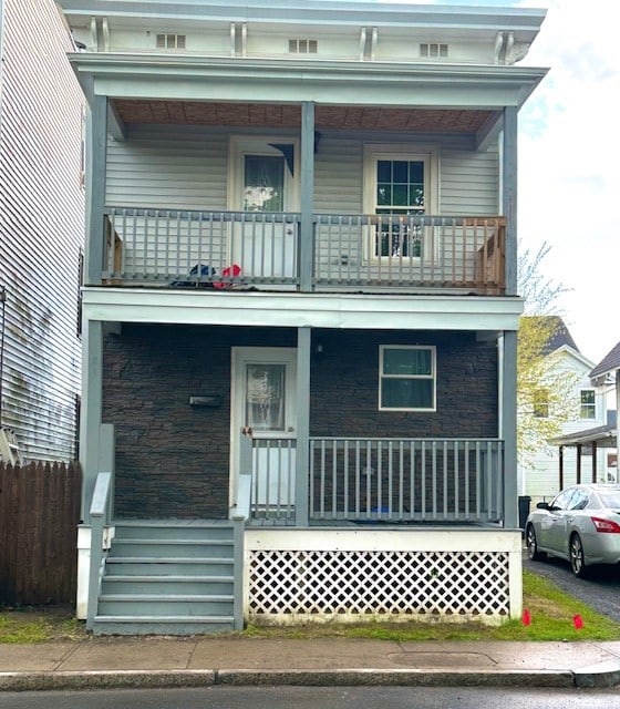 view of front of house with covered porch and a balcony