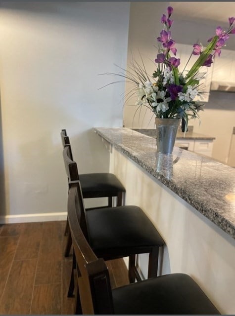 dining room with dark hardwood / wood-style flooring