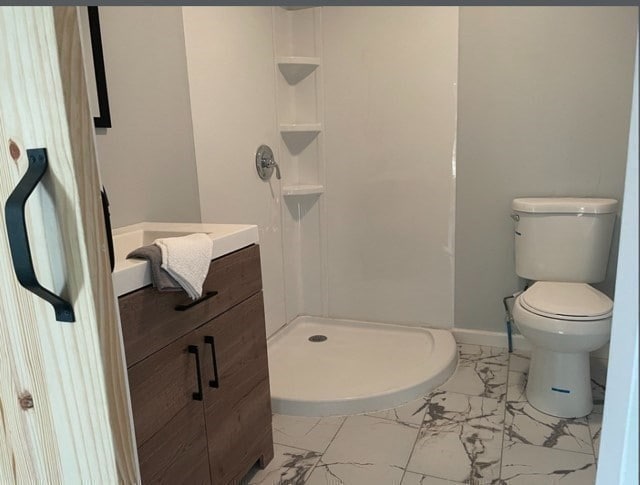 bathroom with walk in shower, tile flooring, toilet, and vanity