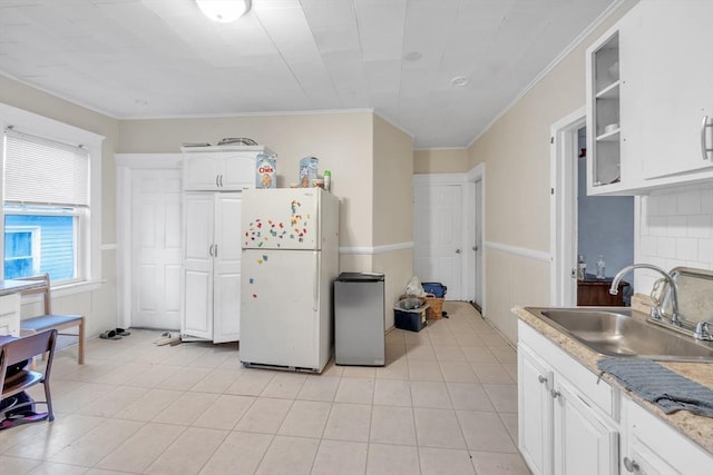 215 Beacon St, Worcester, MA 01610 - kitchen featuring freestanding refrigerator, a sink, crown molding, white cabinetry, and light countertops