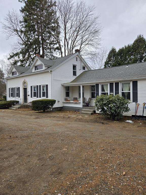 view of front of home with covered porch and a chimney