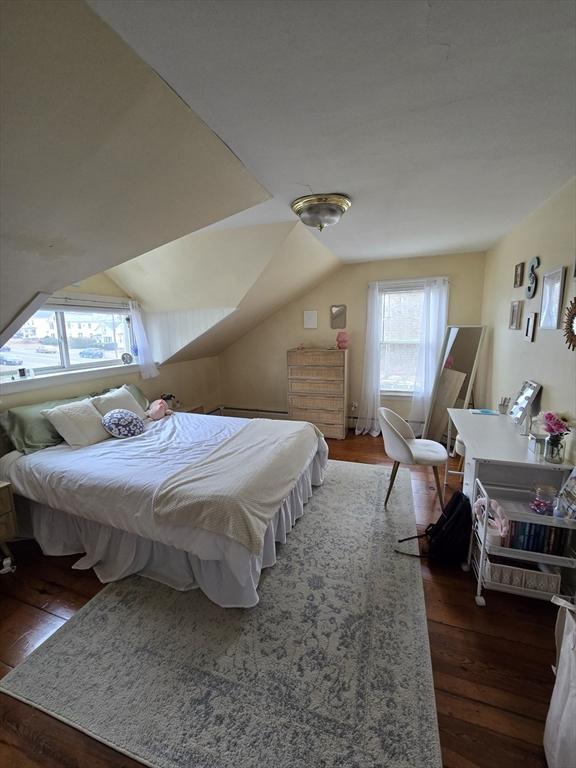 bedroom featuring hardwood / wood-style floors and lofted ceiling