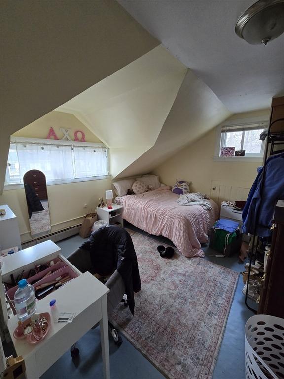 bedroom featuring vaulted ceiling and a baseboard radiator