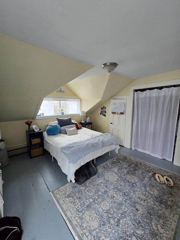 bedroom featuring lofted ceiling and wood finished floors