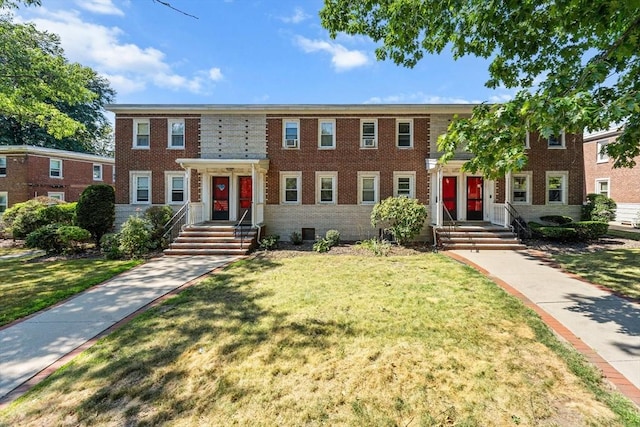 view of front of house with brick siding and a front yard