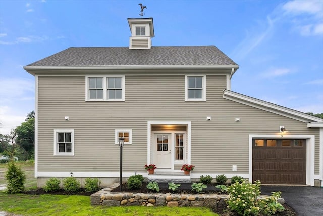 rear view of house featuring a garage