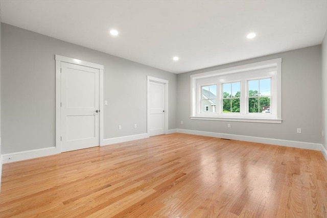 unfurnished room with light hardwood / wood-style floors