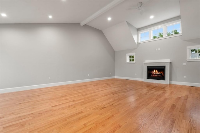 unfurnished living room featuring light wood-type flooring, lofted ceiling with beams, and ceiling fan