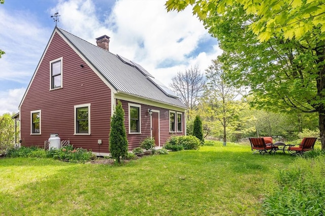 78 Wickett Pond Rd, Wendell, MA 01379 - view of home's exterior with a chimney, a lawn, and a metal roof