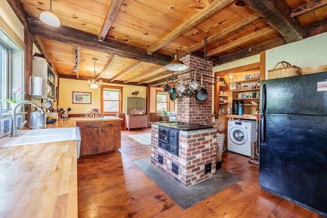 78 Wickett Pond Rd, Wendell, MA 01379 - kitchen featuring freestanding refrigerator, washer / clothes dryer, a wood ceiling with exposed beams, hardwood / wood-style flooring, and a wood stove