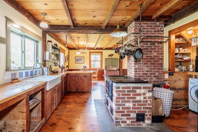 78 Wickett Pond Rd, Wendell, MA 01379 - kitchen with a wood ceiling with exposed beams, washer / dryer, hardwood / wood-style floors, black electric cooktop, and a wood stove