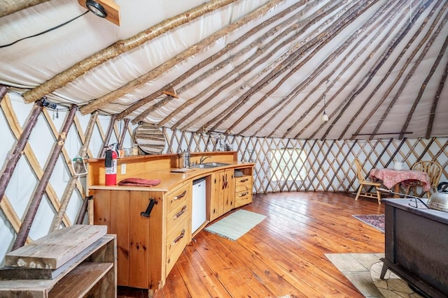 78 Wickett Pond Rd, Wendell, MA 01379 - kitchen featuring light wood finished floors, vaulted ceiling, white dishwasher, light countertops, and wallpapered walls