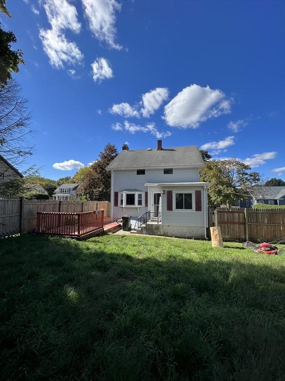 back of property with a chimney