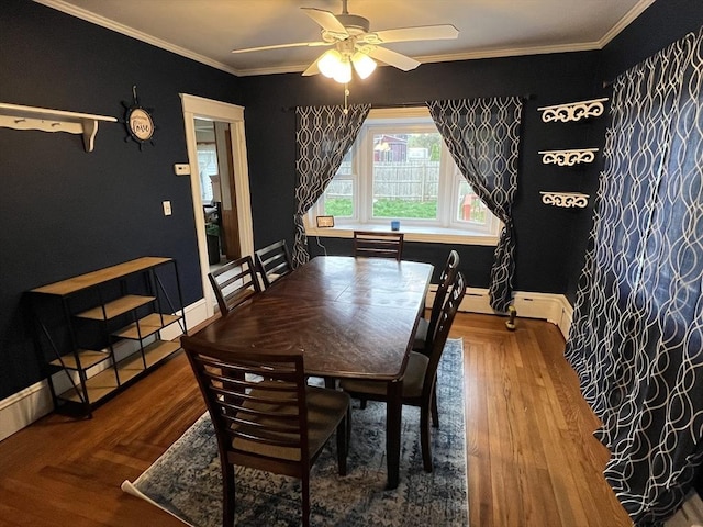 dining space featuring ceiling fan, ornamental molding, baseboards, and wood finished floors