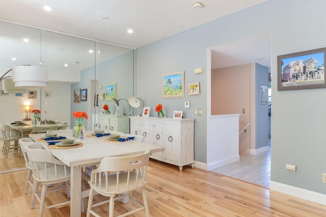 dining room featuring light wood-style floors, baseboards, and recessed lighting