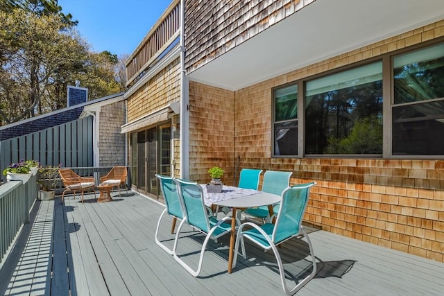 wooden terrace with outdoor dining area