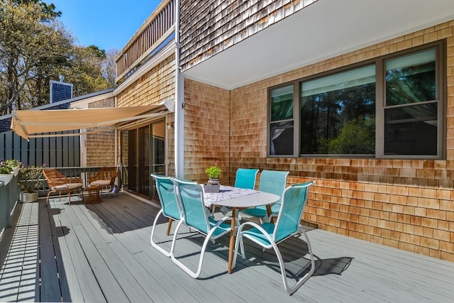 wooden terrace with outdoor dining space