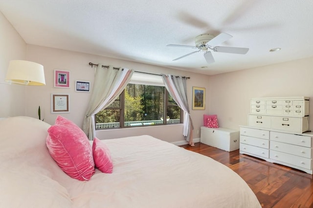 bedroom with baseboards, a ceiling fan, and wood finished floors