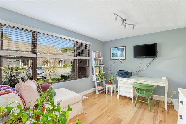 interior space featuring baseboards, wood finished floors, and visible vents