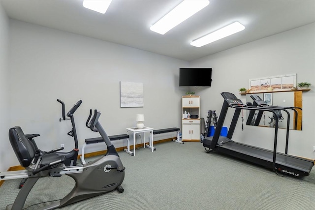 workout room featuring carpet floors and vaulted ceiling