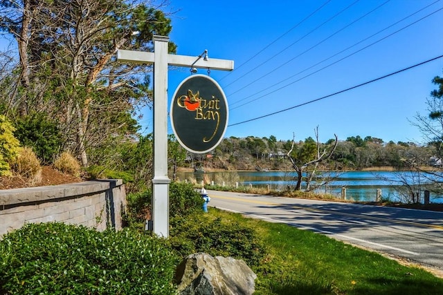 community sign with a water view