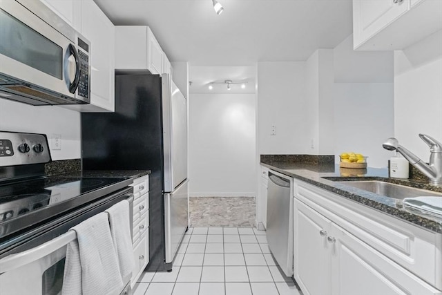 300 Allston Unit 205, Boston, MA 02135 - kitchen with appliances with stainless steel finishes, white cabinets, dark stone counters, and light tile patterned floors