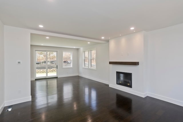 unfurnished living room featuring dark wood-type flooring