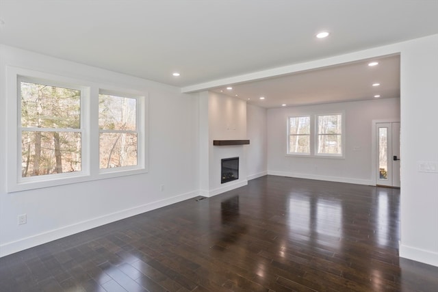 unfurnished living room with dark wood-type flooring