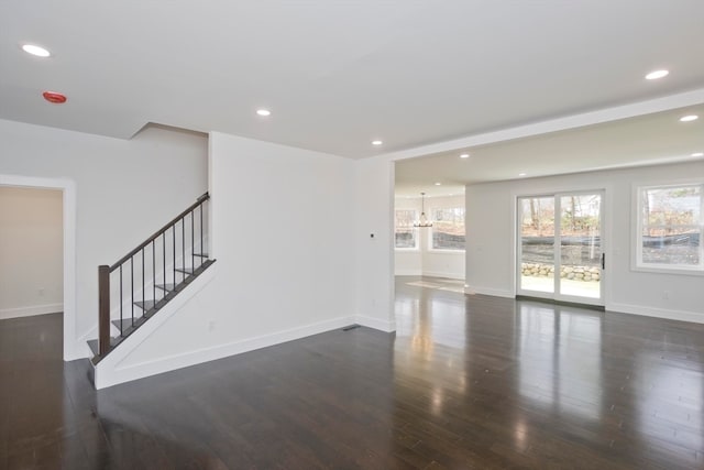 unfurnished living room featuring dark hardwood / wood-style floors