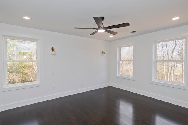 spare room featuring ceiling fan and dark hardwood / wood-style flooring