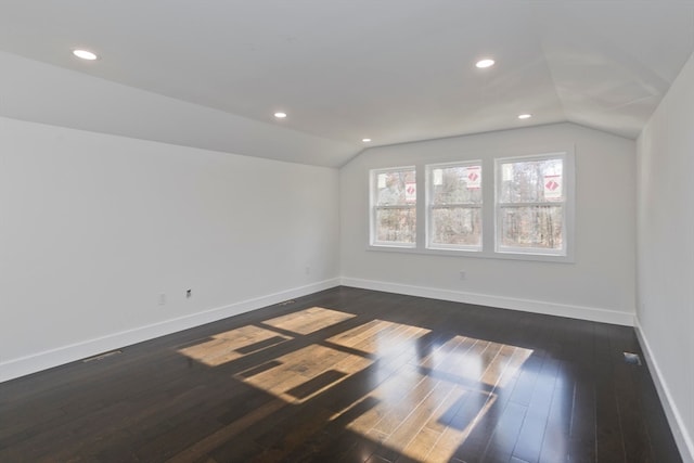 bonus room with dark wood-type flooring and lofted ceiling