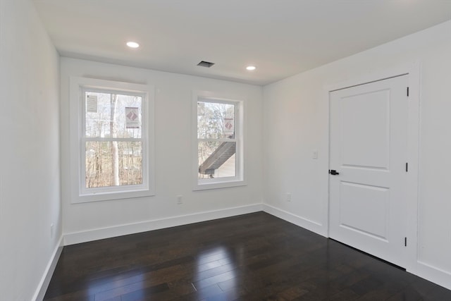 empty room featuring dark wood-type flooring