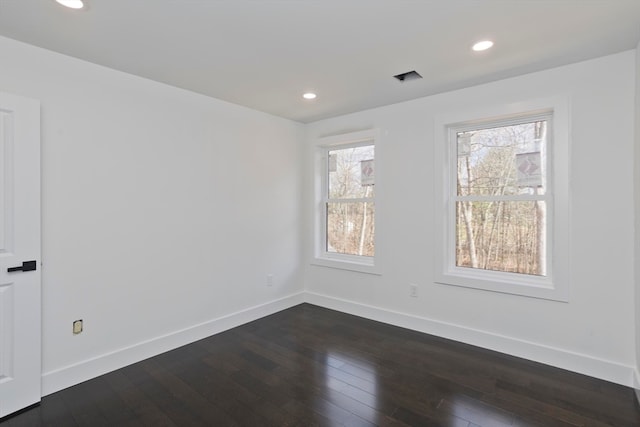 unfurnished room featuring dark wood-type flooring