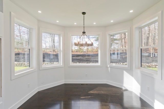 unfurnished dining area featuring dark hardwood / wood-style flooring and a healthy amount of sunlight