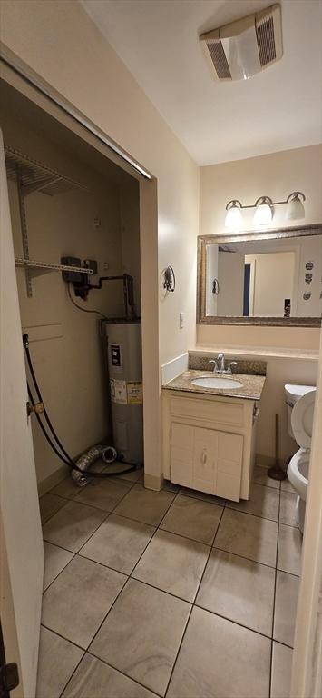 800 Bearses Way Unit 5Nb, Barnstable, MA 02601 - bathroom featuring water heater, vanity, and tile patterned flooring