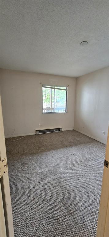 800 Bearses Way Unit 5Nb, Barnstable, MA 02601 - spare room featuring carpet floors, baseboard heating, and a textured ceiling
