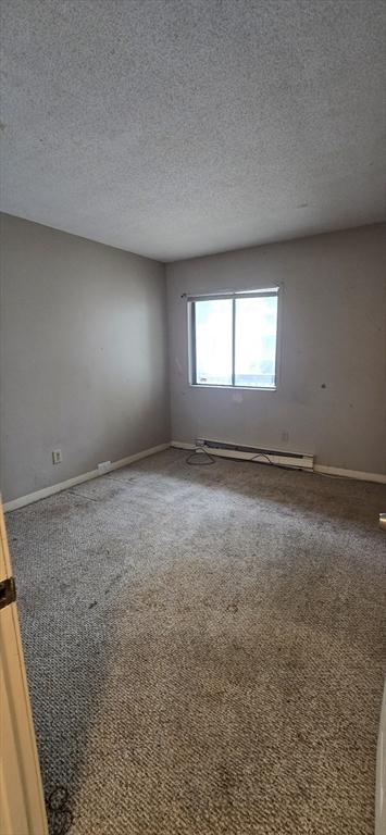 800 Bearses Way Unit 5Nb, Barnstable, MA 02601 - carpeted spare room with a baseboard radiator and a textured ceiling