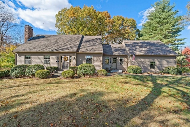 rear view of property featuring a yard