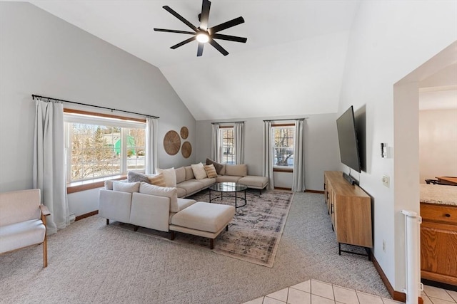 carpeted living room with ceiling fan, lofted ceiling, and plenty of natural light