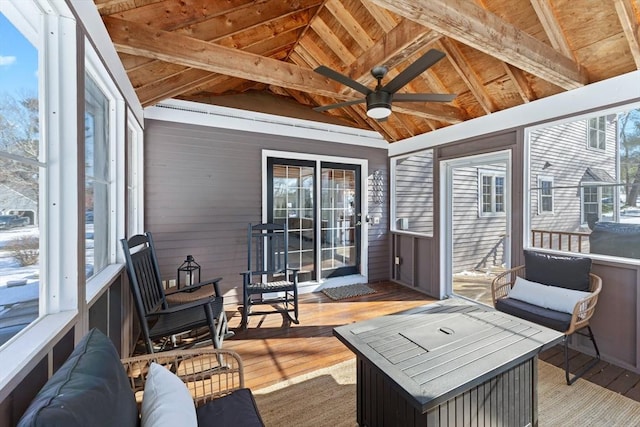 sunroom featuring plenty of natural light, lofted ceiling with beams, and wooden ceiling