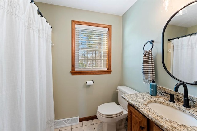 bathroom with vanity, tile patterned floors, and toilet