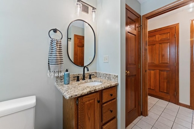 bathroom featuring vanity, toilet, and tile patterned flooring