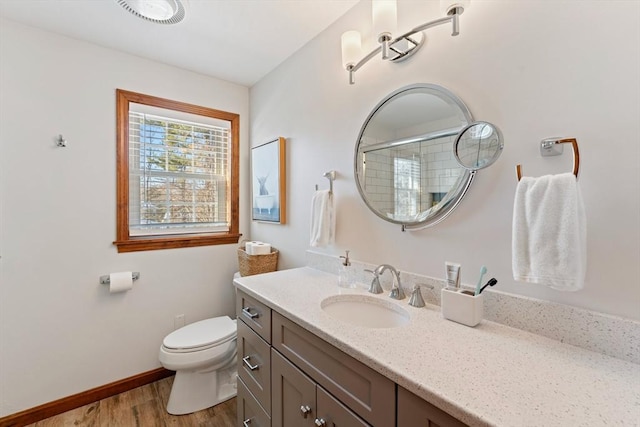 bathroom featuring walk in shower, vanity, toilet, and hardwood / wood-style floors