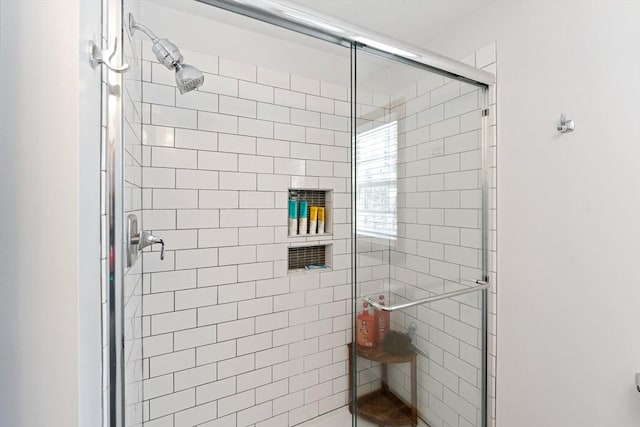 bathroom featuring a shower with door