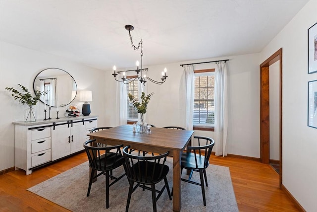 dining space with an inviting chandelier and light wood-type flooring