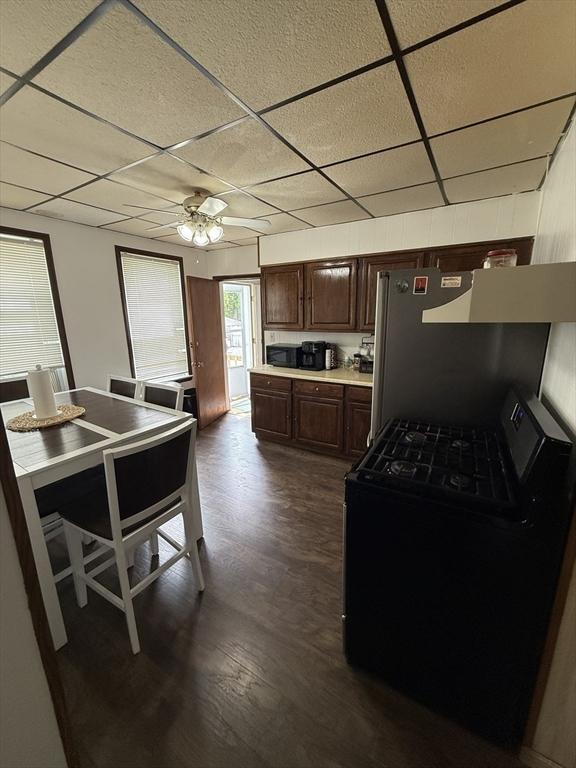 50 Proctor Ave, Revere, MA 02151 - kitchen featuring black gas range oven, a drop ceiling, dark wood-type flooring, light countertops, and ceiling fan