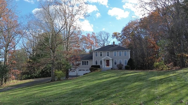 view of front of house with a garage and a front yard