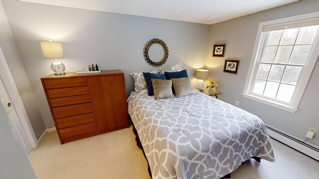 carpeted bedroom featuring a baseboard radiator and a closet