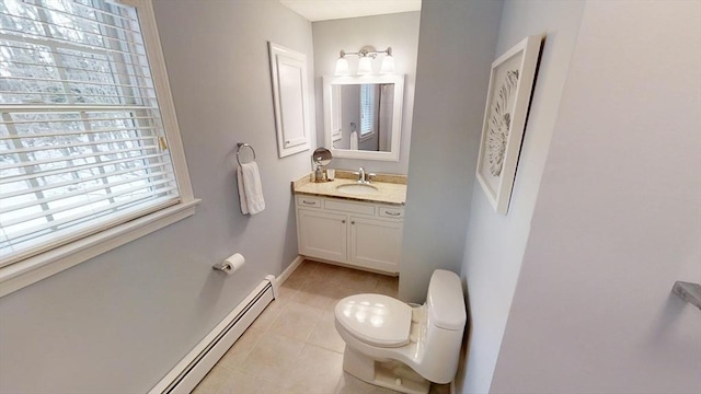 bathroom featuring vanity, toilet, tile patterned flooring, and a baseboard heating unit